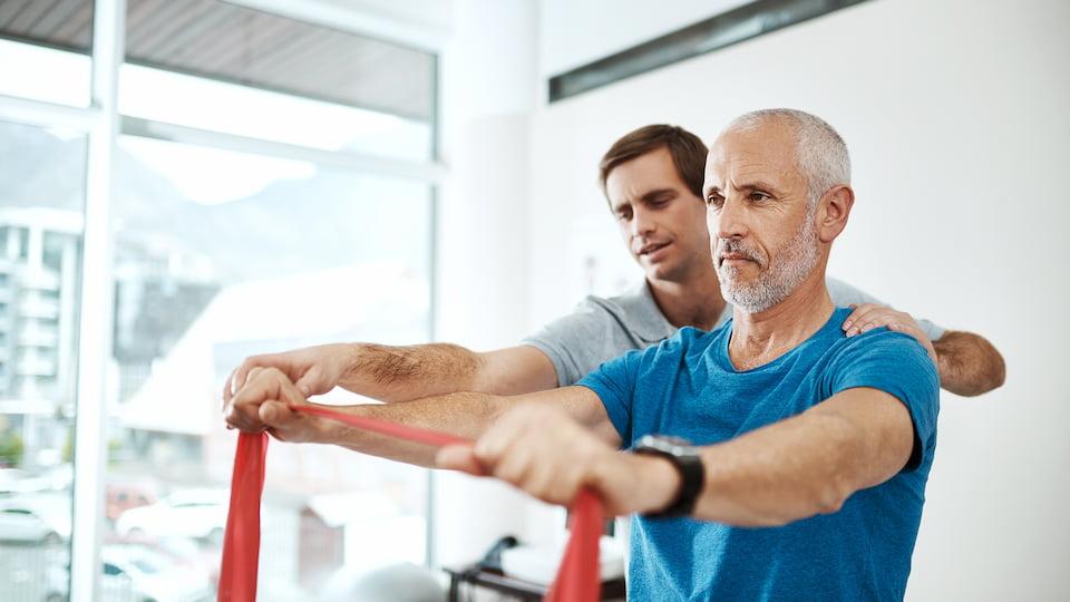 Man helping another man exercise